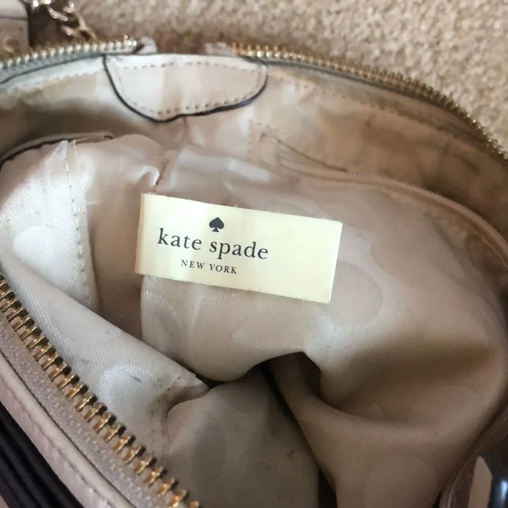 Kate Spade cream purse with a black bow